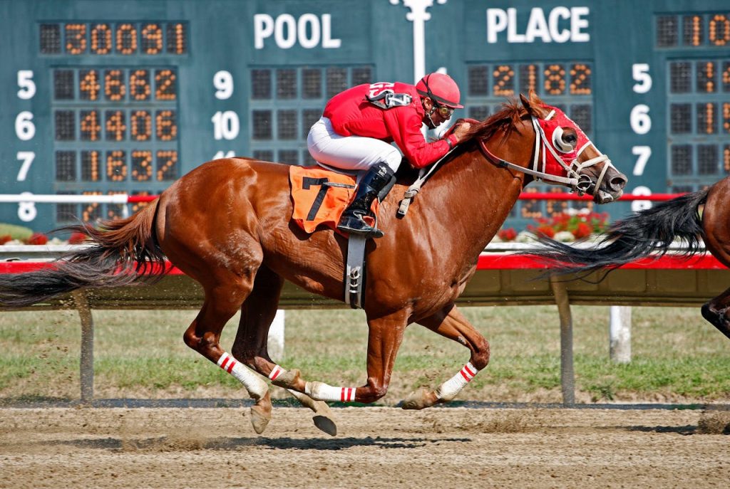 Dramatic horse racing scene with jockey in red competing fiercely on the track.